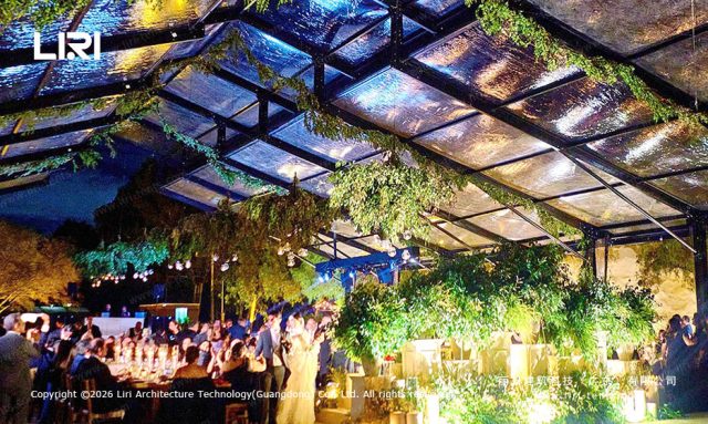 PM25m Pastoral Marquee interior wedding dinner setup - glass walls, chandeliers, woven chairs, sunset lighting, Mexico venue