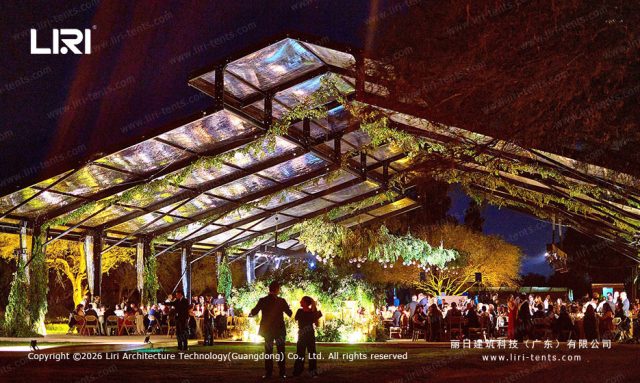 Night aerial view PM30m Pastoral Marquee - transparent roof with LED lighting, crystal palace effect, colorful glass walls