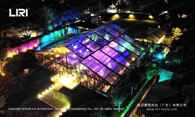 Long table dinner setup Pastoral Marquee - floral centerpieces, glass walls, transparent roof, luxury wedding venue