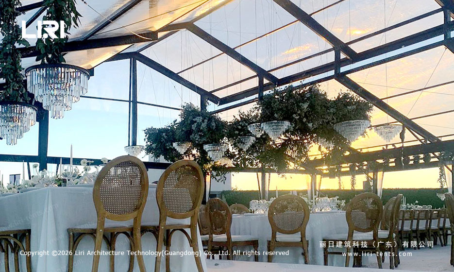 PM25m Pastoral Marquee interior dinner setup - glass walls, chandeliers, sunset, Mexico venue