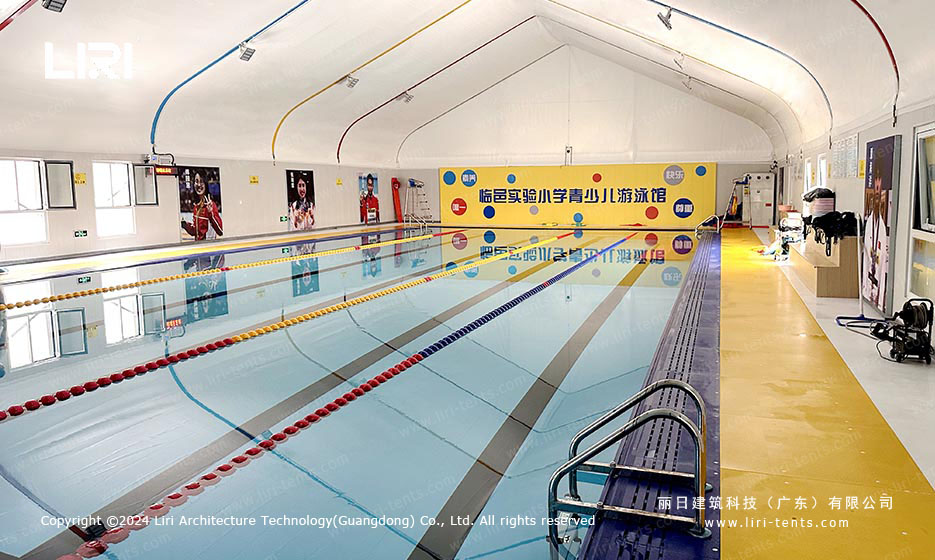 full interior view of competition swimming pool inside large clear span marquee tent
