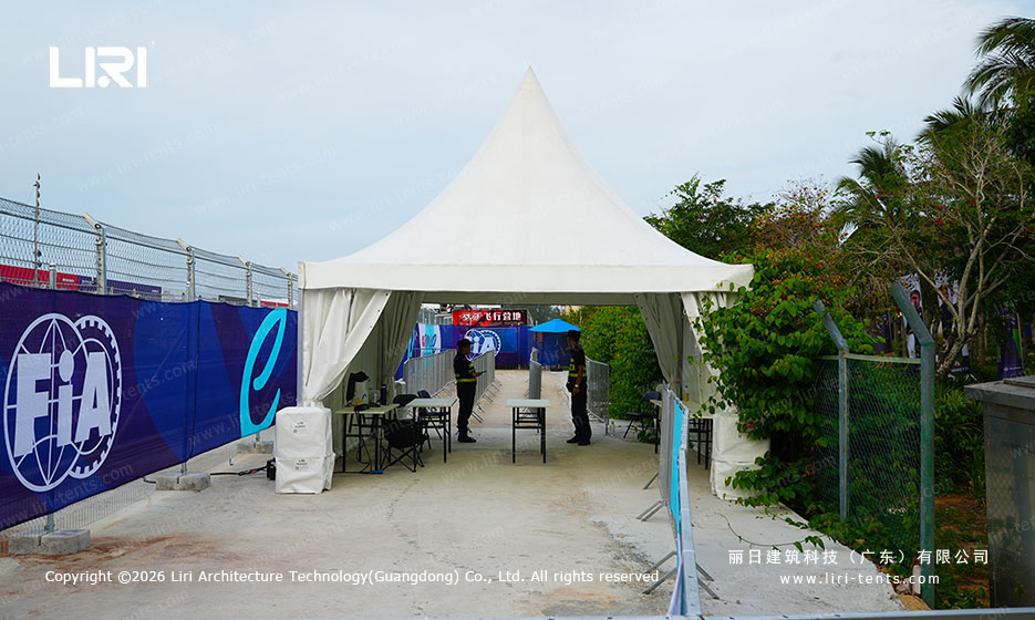 Pagoda tent at the FIA branded security checkpoint with crowd control barriers