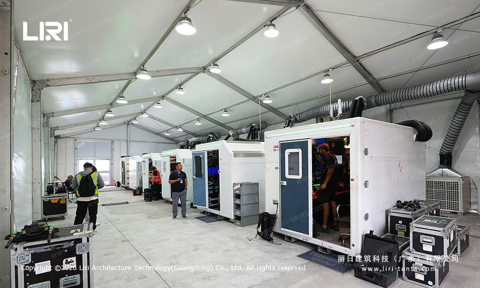 Broadcasting and AV equipment inside the motorsport media tent with overhead HVAC ducts