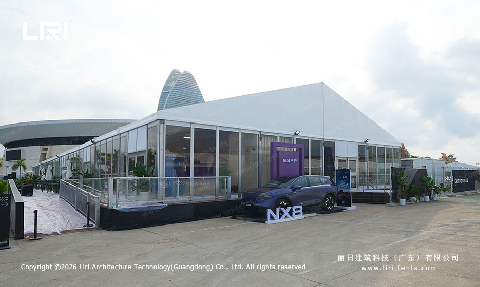 Glass wall car display pavilion showcasing a NX8 vehicle at the Sanya race