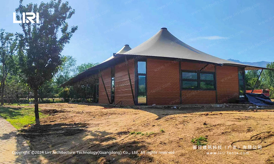 Glass wall tent exterior with wooden cladding and peak roof