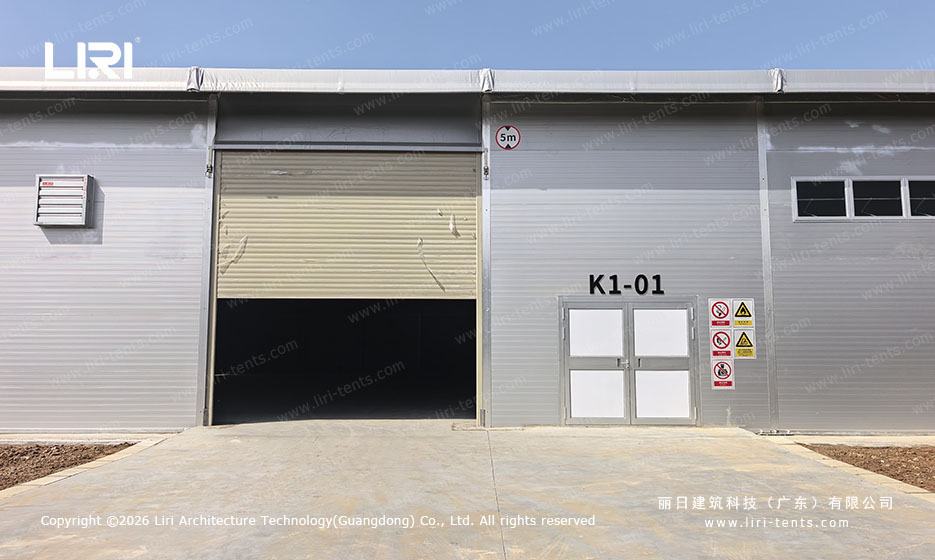 Roll-up door access on clear span hangar tent