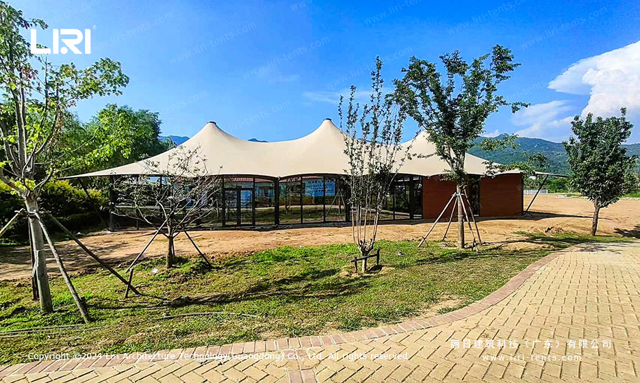 Luxury party tent pavilion with glass walls and landscaped setting