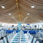 Party tent banquet hall interior with table settings