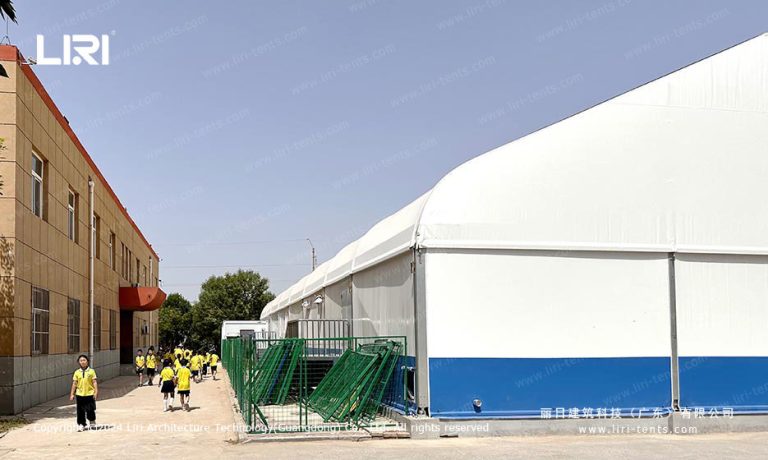 clear span swimming pool tent exterior side view next to school building