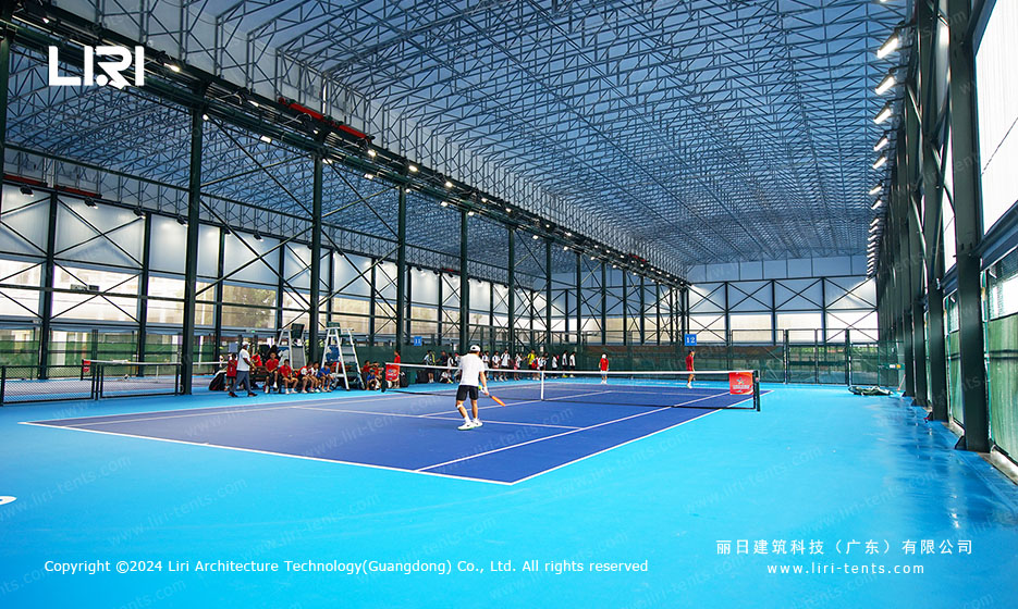 Tennis players during match inside covered aluminum hall