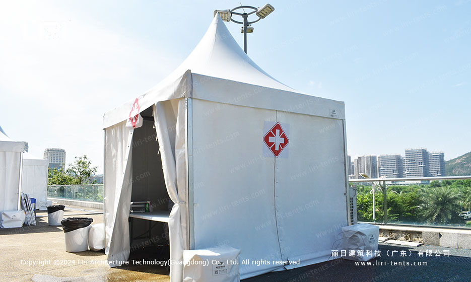 white pagoda party tent set up as a medical first aid station beside the tennis stadium