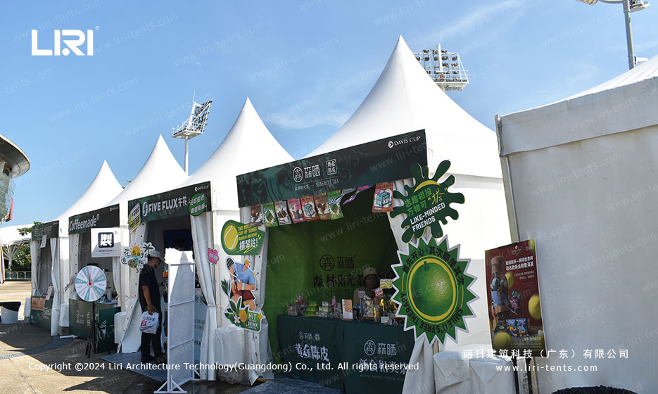 white pagoda tent row used as brand activation village for tennis tournament