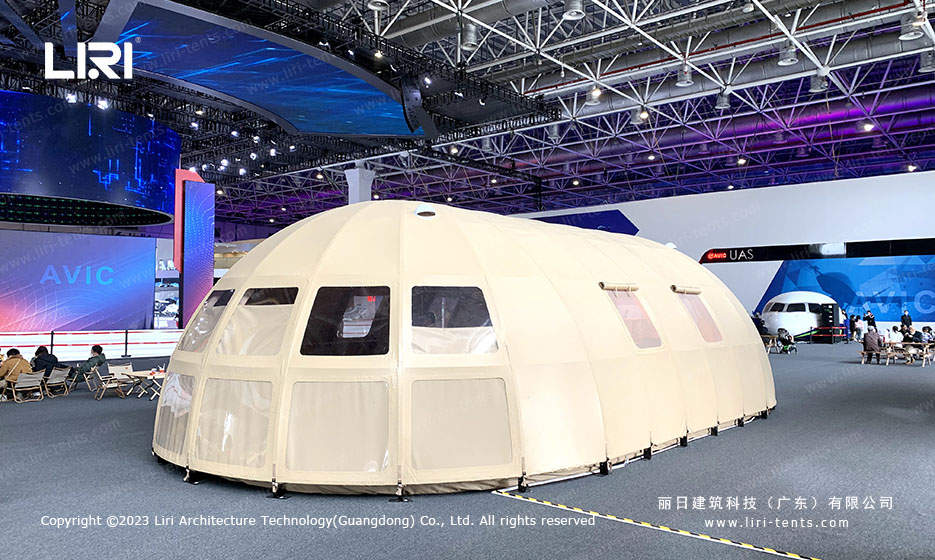white tepee tent indoor trade show setup with timber rafters