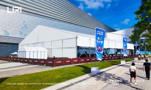 Front aerial view of an opening ceremony party tent installed on a Shenzhen urban plaza with banner flags and ice block entry decoration for a winter brand launch