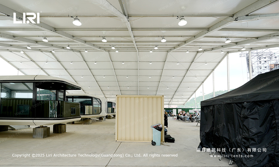 Reception and entrance area inside an award ceremony party tent with a classical-style decorative facade and black side tarp