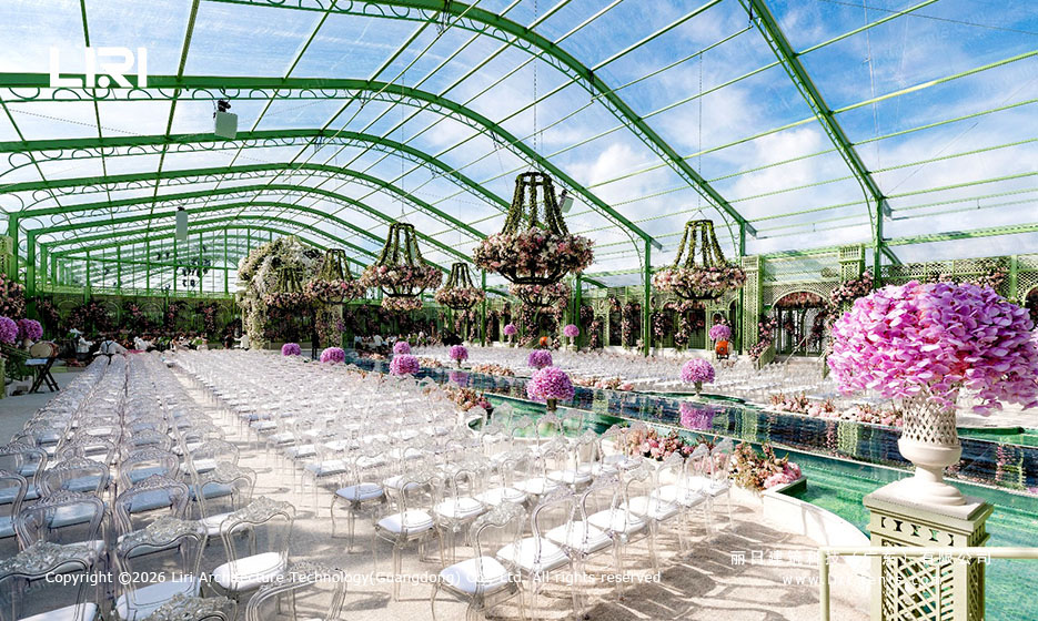 arcum aluminum orangery with green frame set up as a banquet hall with central water feature and floral chandeliers