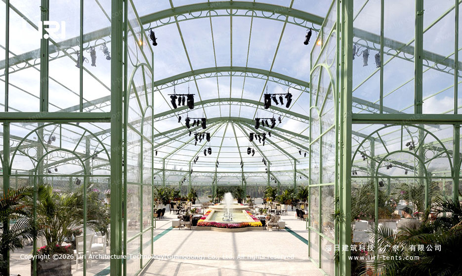 Arcum Aluminum Orangery Interior Glass Arches arcum aluminum orangery interior showing the curved glass arches and green aluminum structure with hanging light fixtures