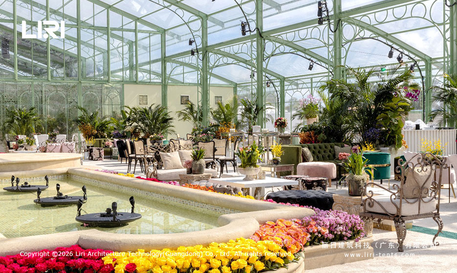 Arcum Aluminum Orangery Lounge Water Feature arcum aluminum orangery lounge area with green frame, vintage seating, and shallow water feature with floating flowers