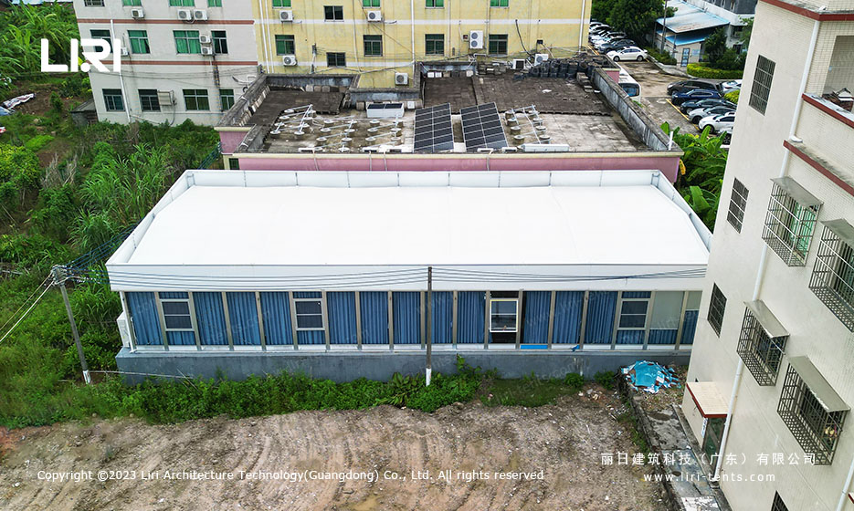 Flat-roof meeting room tent with full glass walls on the long side