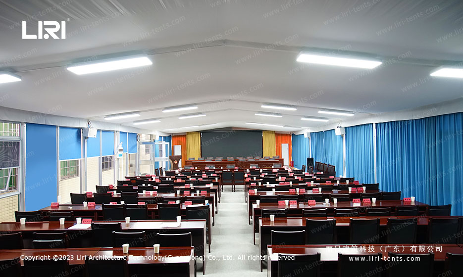 Flat-roof tent used as a restaurant dining hall with perimeter curtains drawn